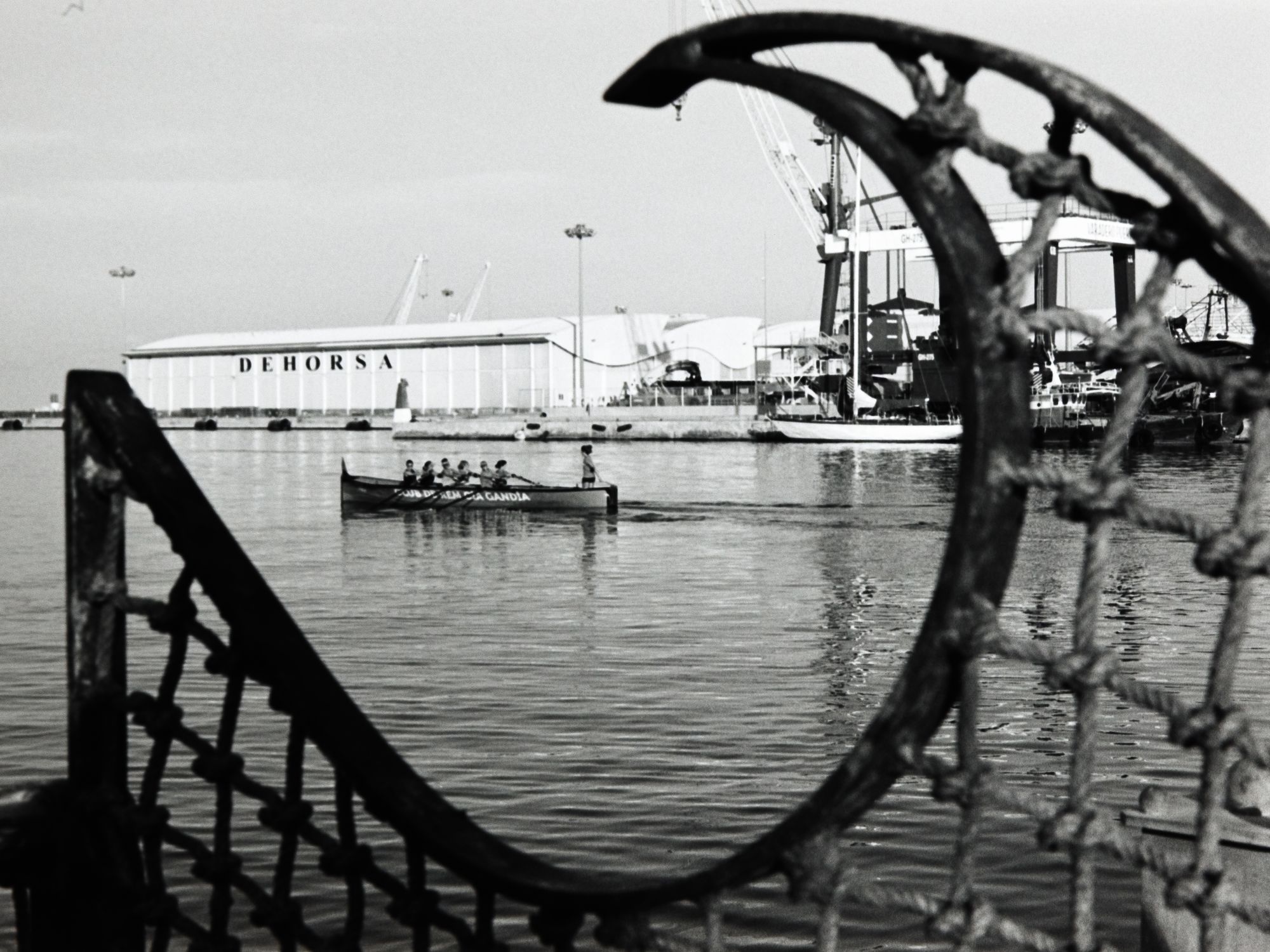 A black and white photo of a rowing team practicing