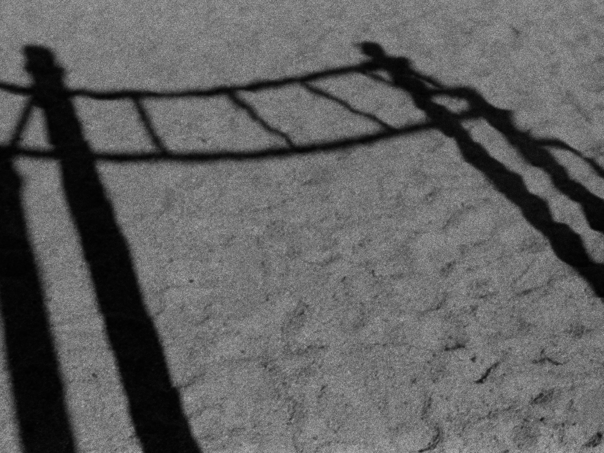 A shadow of a kid's playground element