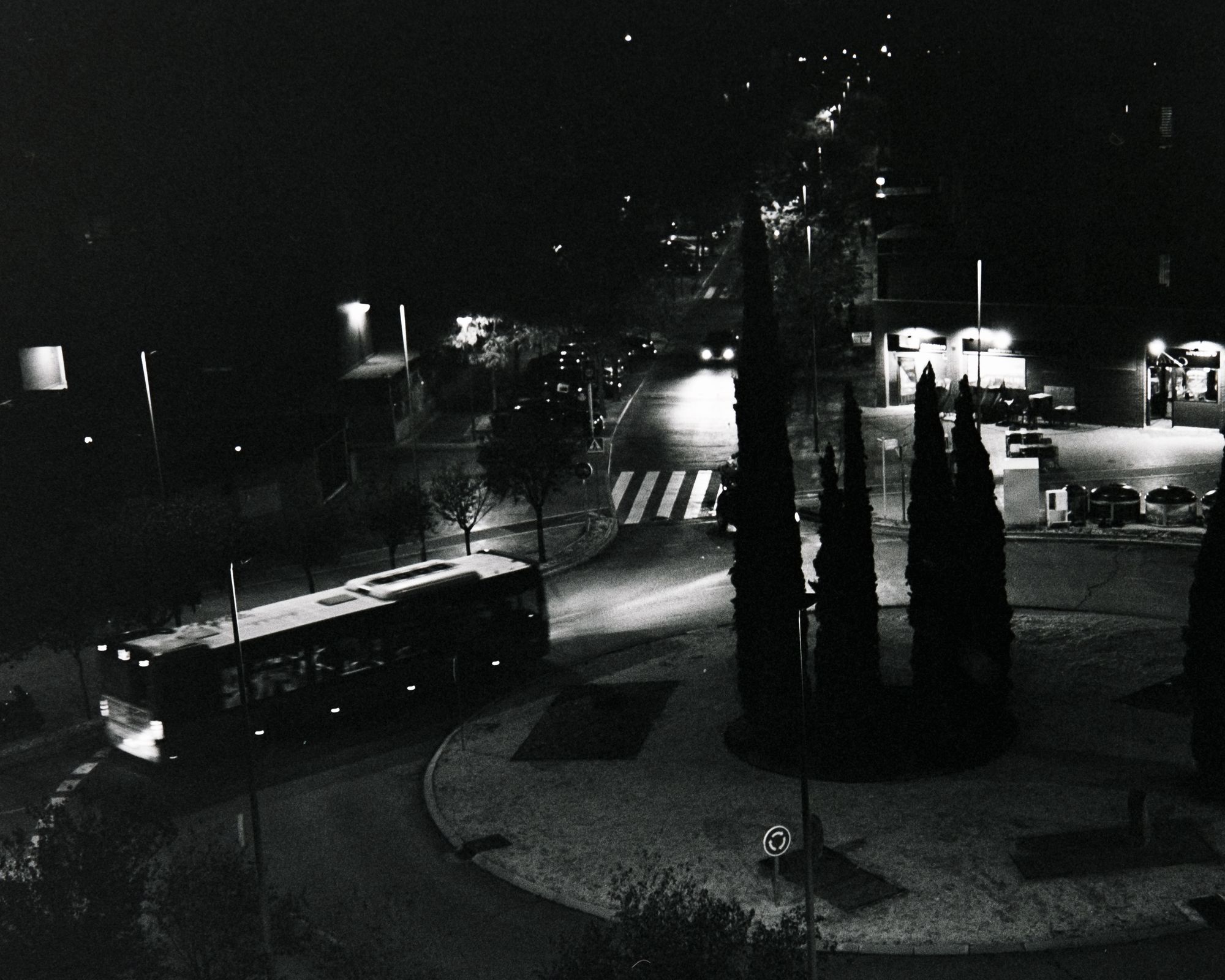 A bus moving through the night in a roundabout